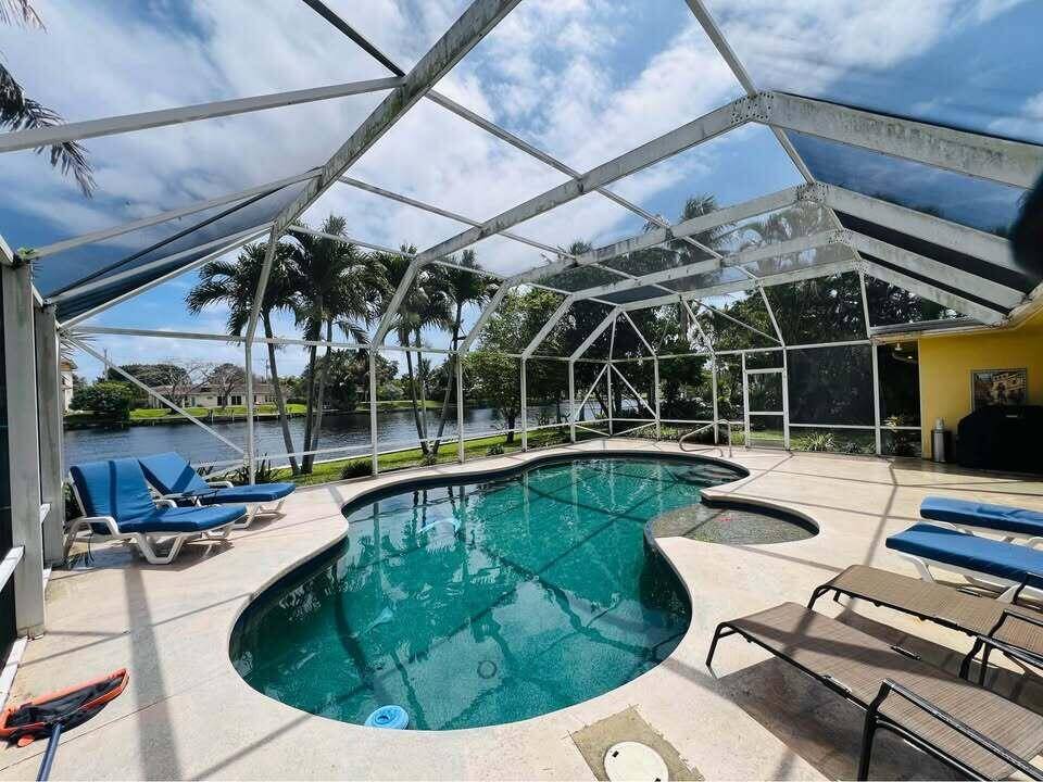 Experience a slice of the desirable South Florida Lifestyle in this Spacious, Waterfront Home.