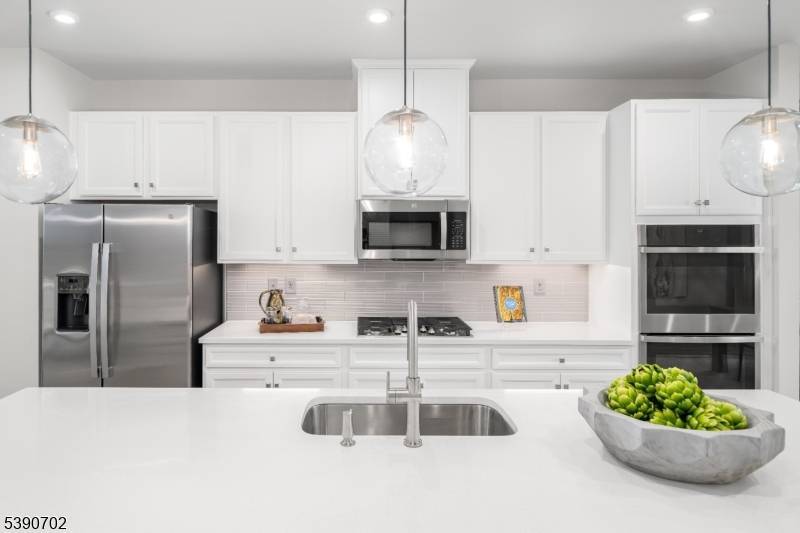 Welcome to the Schubert at The Anchor at Glassworks II a spacious townhome offering luxury and ease across three finished levels.