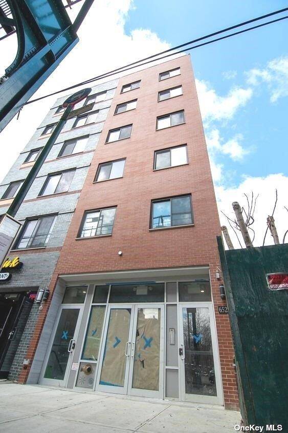 Recently renovated 1, 200 SF white box with tile finishes and natural light.