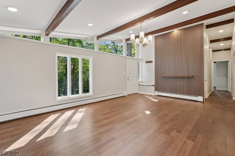 Welcome home to this beautifully renovated 4 bedroom, 3 bathroom Raised Ranch, perfectly nestled on a private wooded lot in the heart of Wayne.