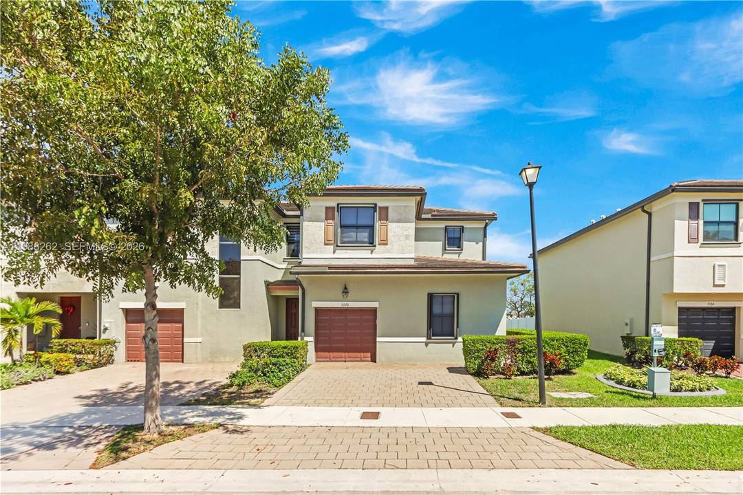 Beautiful corner unit townhome with stunning lake views in the sought after Aquabella community.