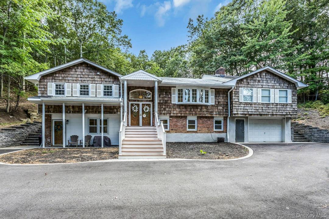 Nestled in the serene woods of Fort Salonga, this home provides an unparalleled sense of privacy.