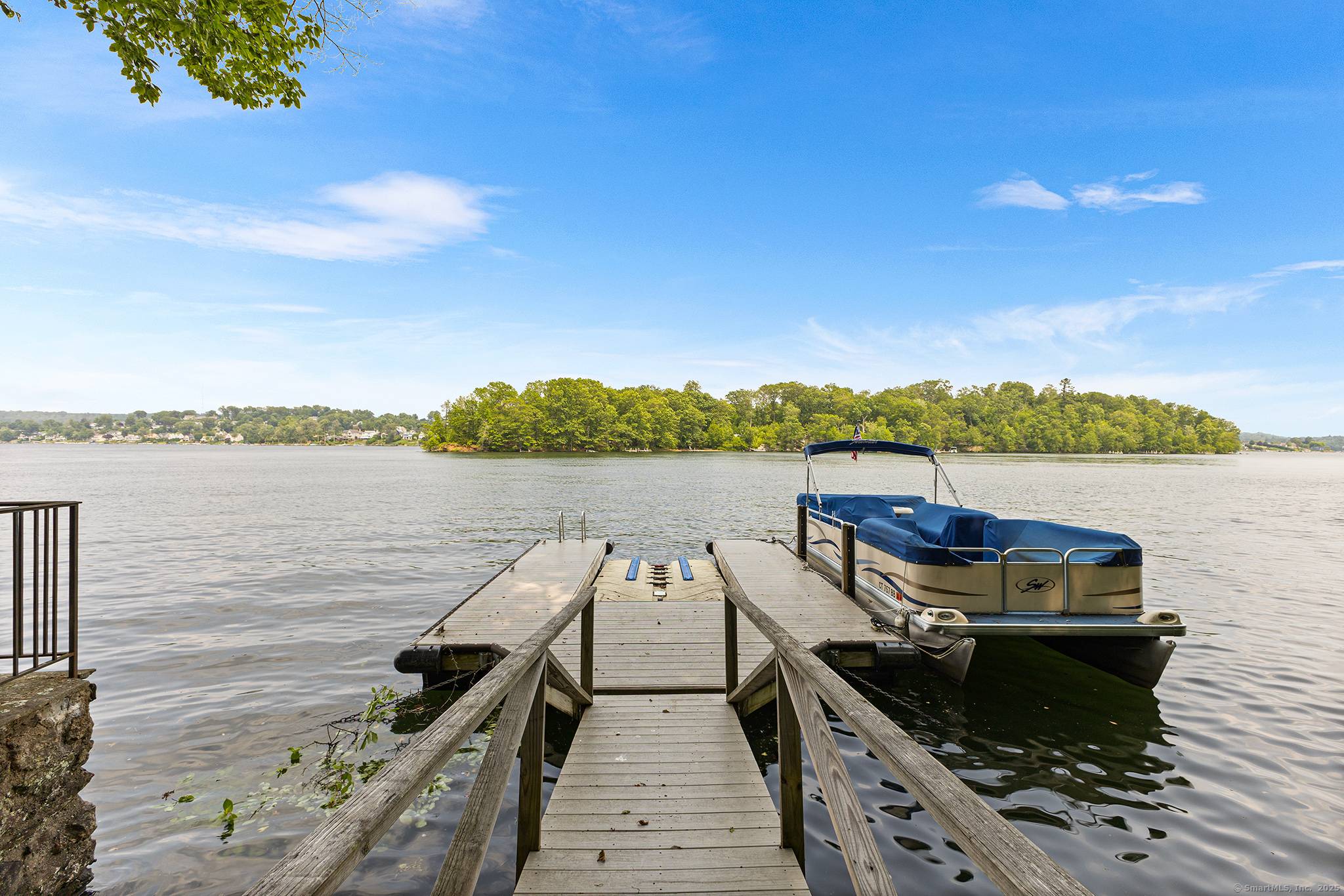 Welcome to this beautifully expanded vintage cottage on sought after Candlewood Isle.