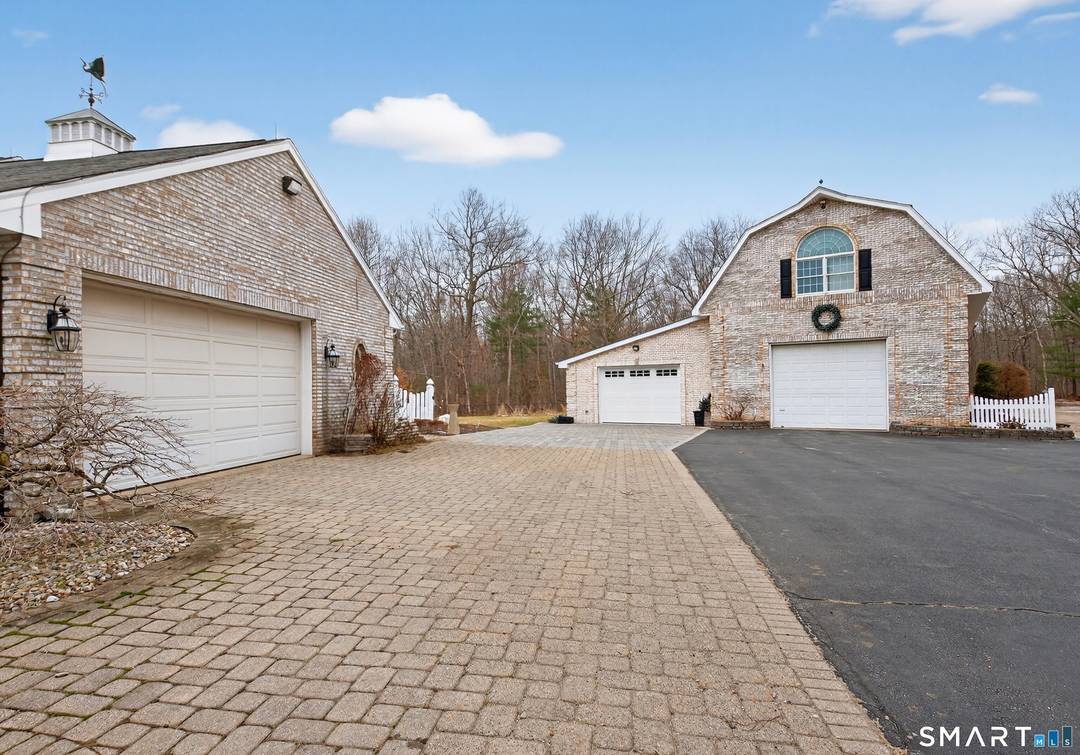 Welcome to this beautifully maintained home set on over 10 private acres in desirable South Windsor.