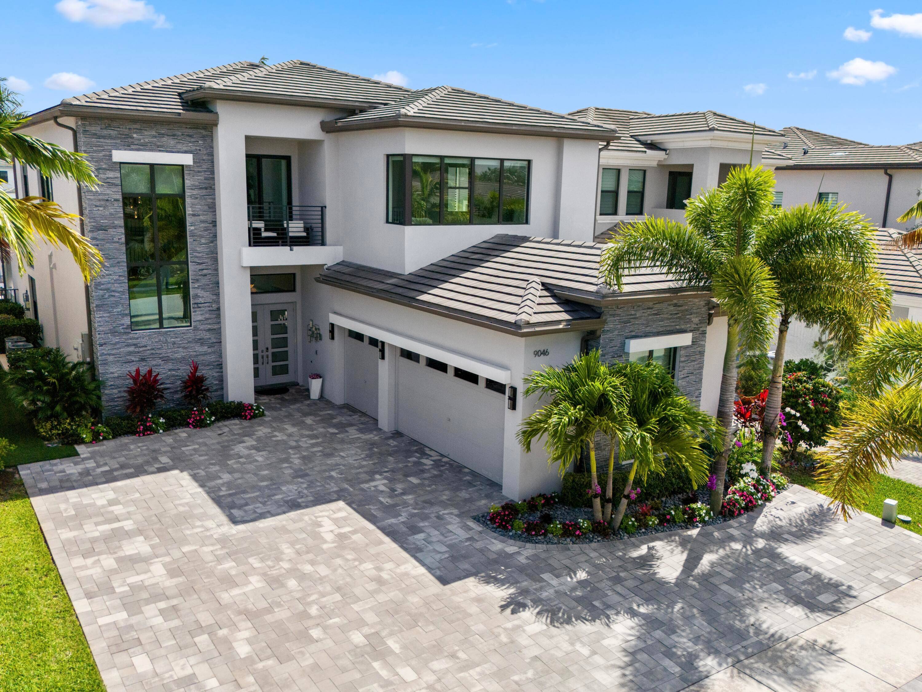 Welcome to 9046 Chauvet Way, an exquisite lakefront residence in the prestigious Boca Bridges community.