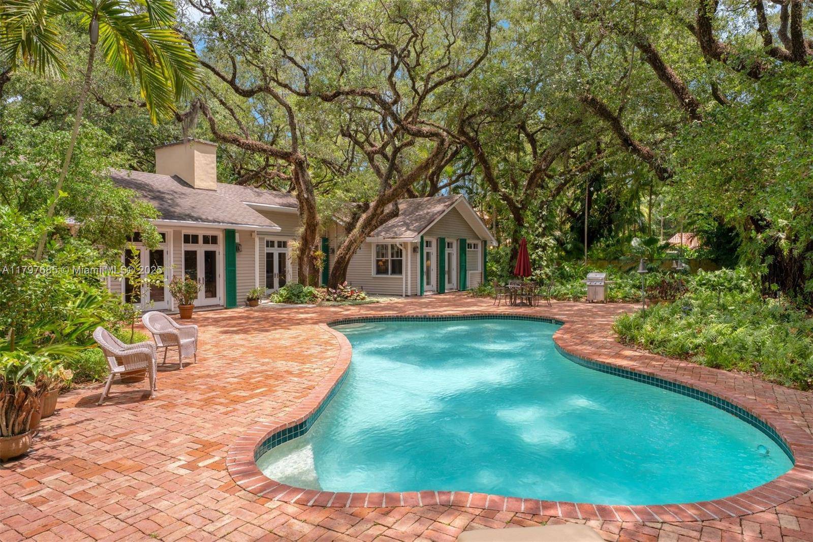Ponce Davis storybook acre estate of lush, curated tropical specimens amp ; majestic oaks.