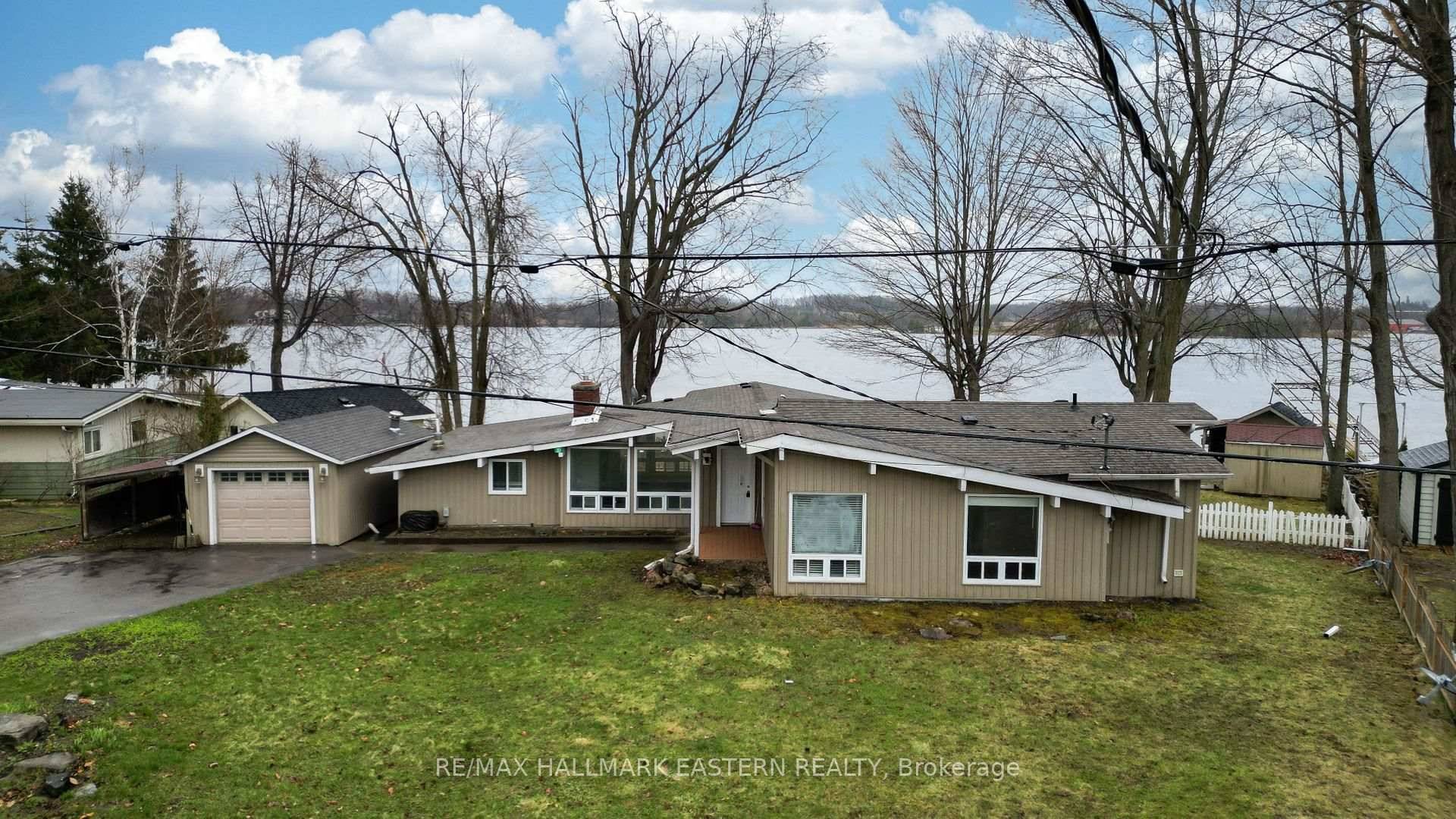 WATERFRONT GEM IN THE HEART OF IT ALL Discover the epitome of lakeside living with this waterfront gem offering 1, 926 square feet of main floor living on virtually one ...
