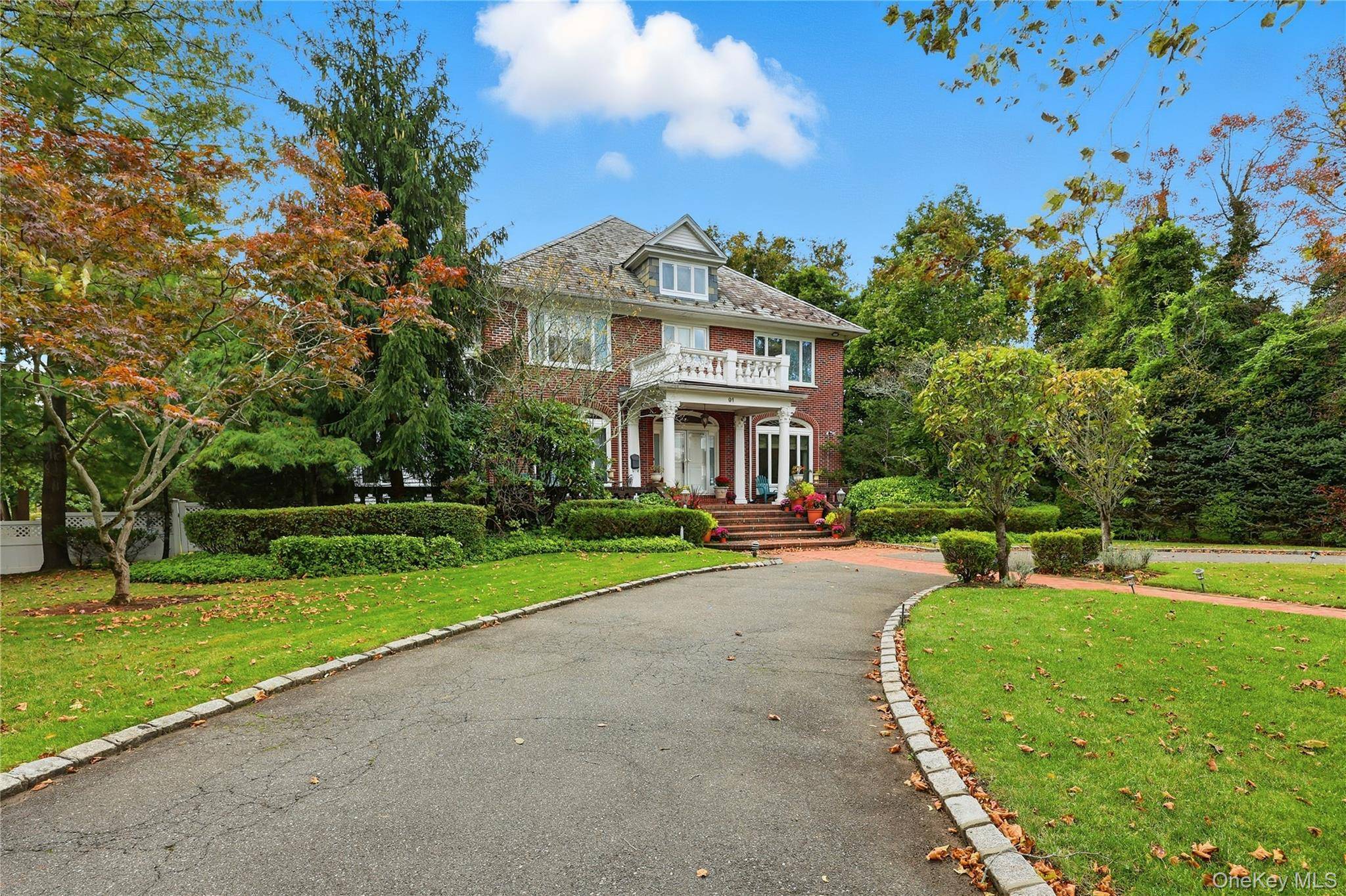 Set on nearly half an acre on one of Woodsburgh s most desirable streets, this elegant brick Colonial blends timeless charm with modern comfort.