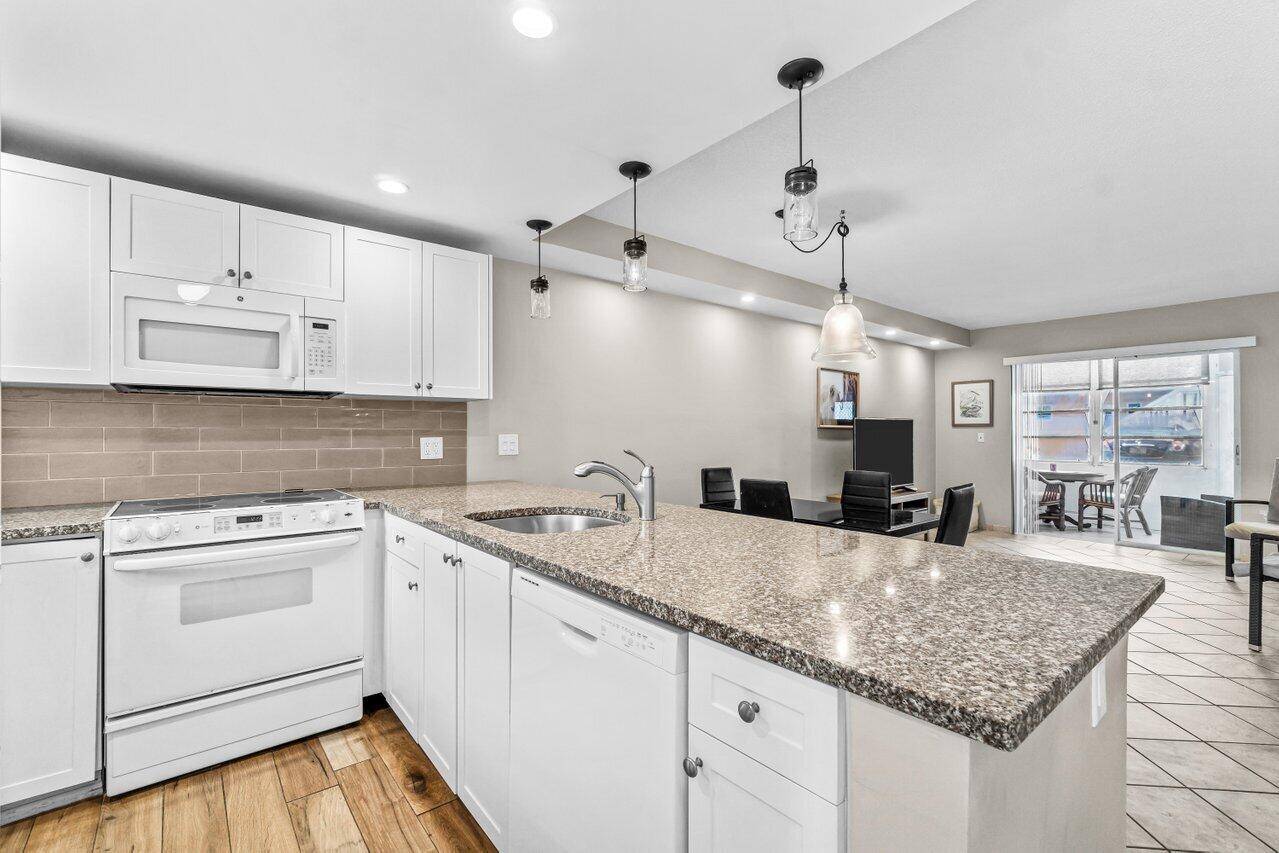 Updated ground floor 2 bed, 2 bath corner unit in 55 Village Royale perfect for a seasonal escape or full time Florida living !