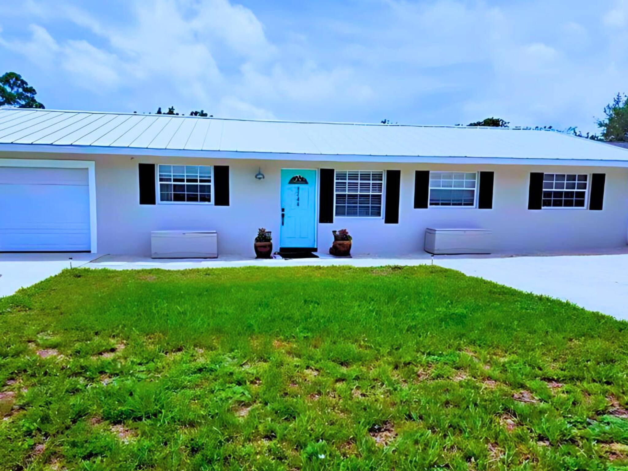 Discover this charming 4 bedroom, 2 bathroom home with a 1 car garage, ideally located east of Dixie Highway in Hobe Sound, Florida.