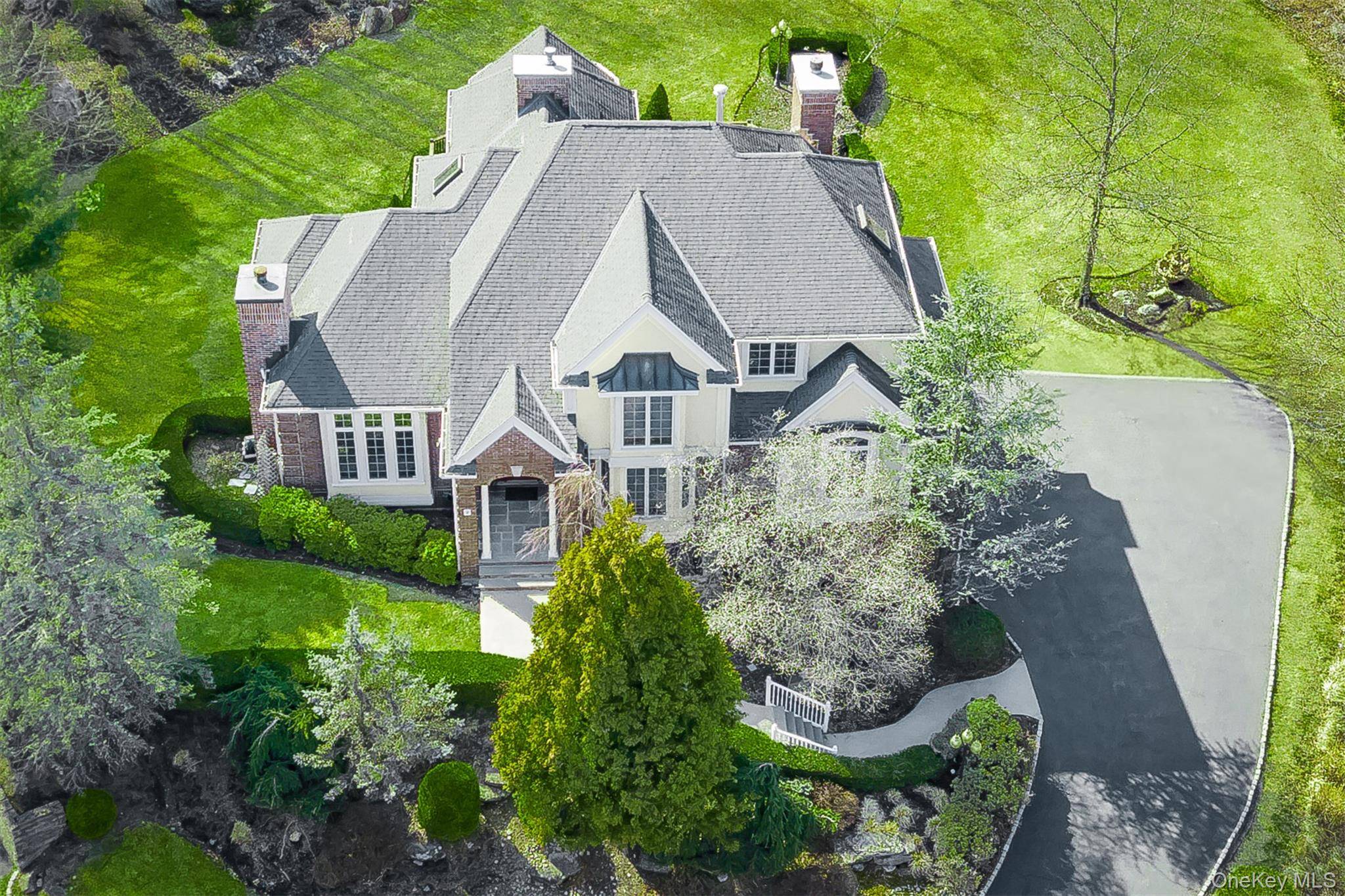 This magnificent colonial is nestled in a serene cul de sac with meticulously landscaped property which boarders state park land.