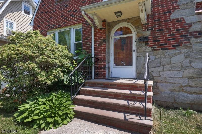 This charming 3 bedroom Tudor style stone and brick home offers spacious rooms and timeless character throughout.