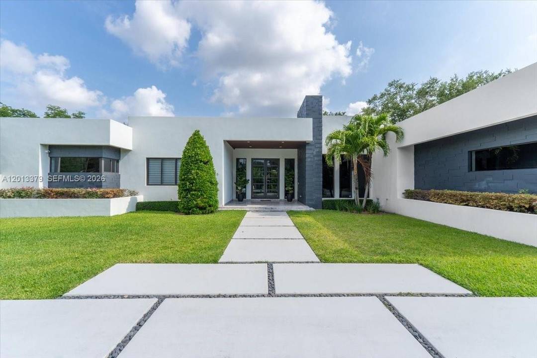 Exquisite modern estate completed in 2021, ideally positioned on a prime corner lot in the prestigious enclave of North Pinecrest.