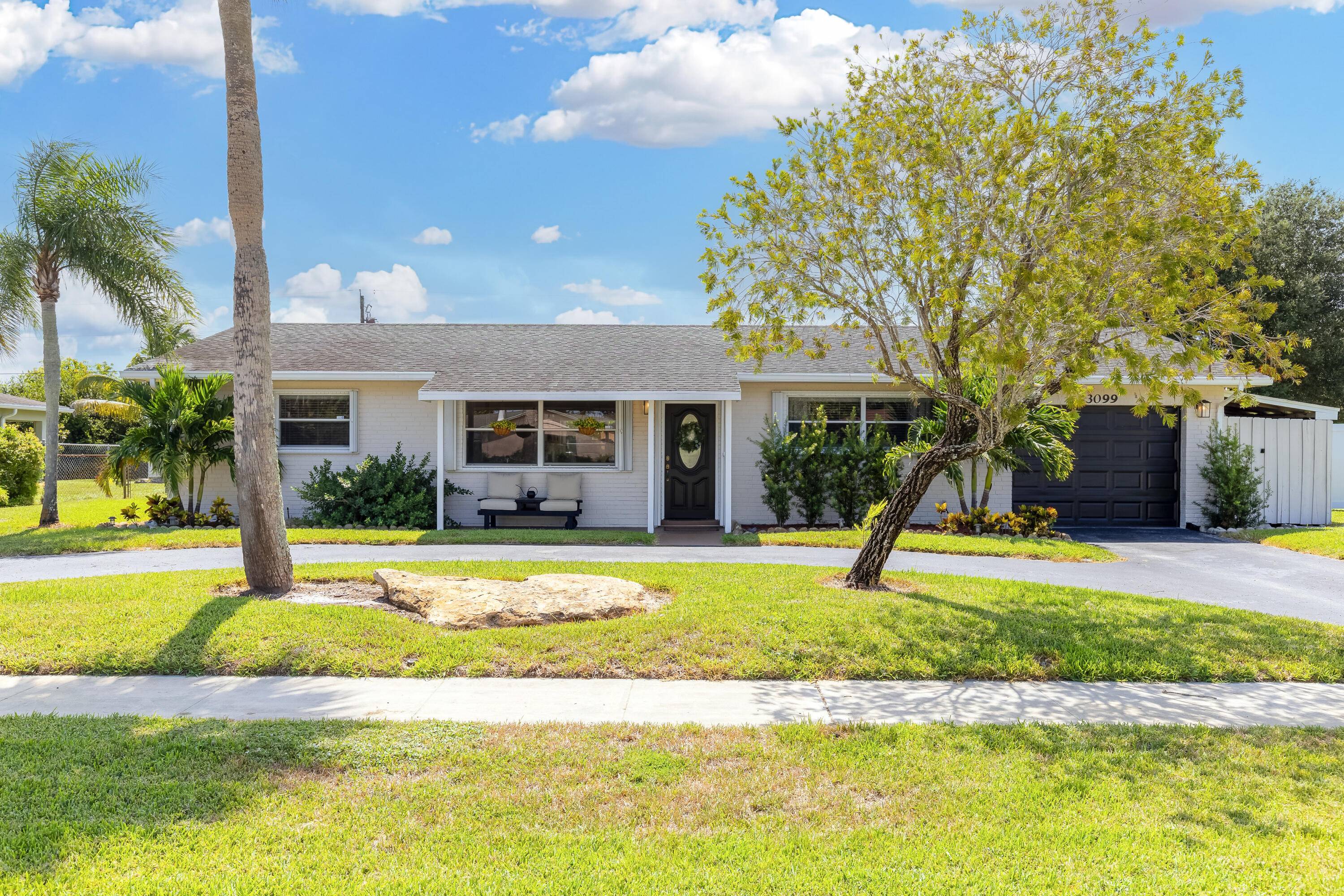 Welcome to 3099 Medinah Circle E, a beautifully updated 3 bedroom, 2 bath pool home nestled in the heart of the Palm Beach National Golf and Country Club a rare, ...