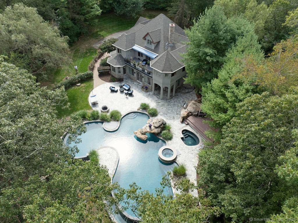 Resort like gated estate perched high above Sachem Head Road overlooking a saltwater tidal marsh nestled on 2.