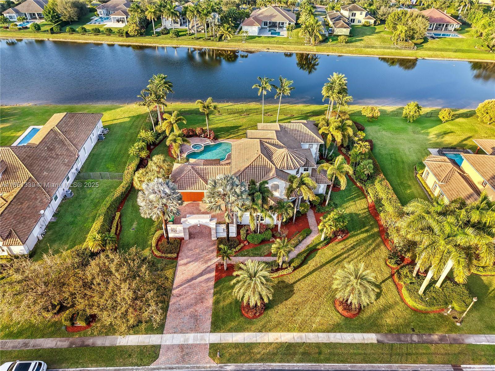 Discover private elegance in this Mediterranean and Spanish inspired lakefront estate on a builder s acre in a gated community.