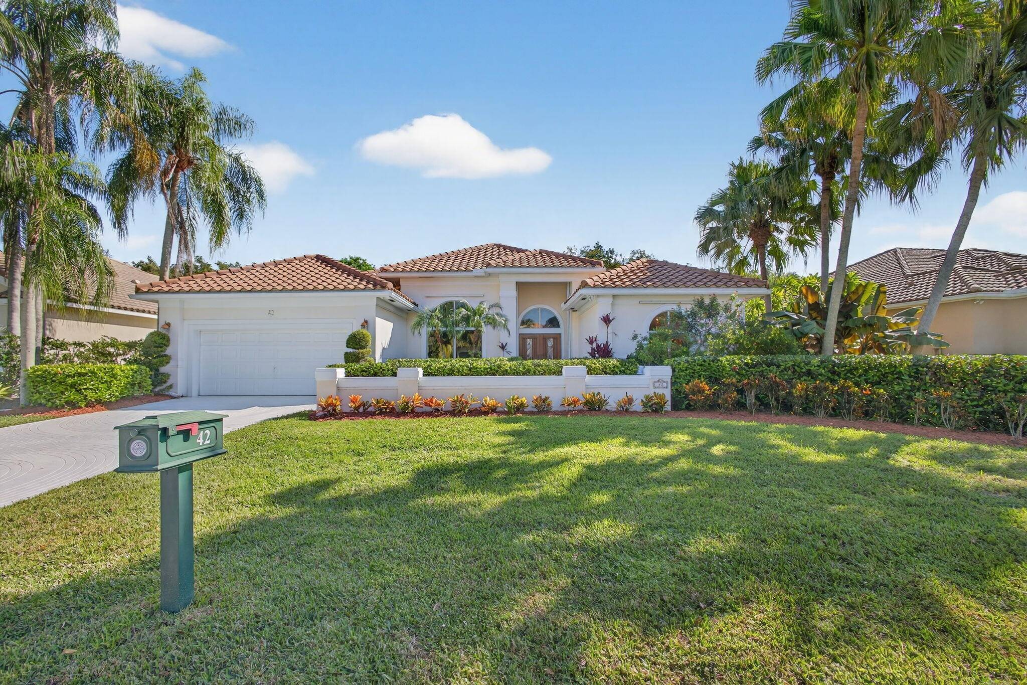 Elegant one level home in the coveted gated community of ''THE ISLAND'' in PGA National.