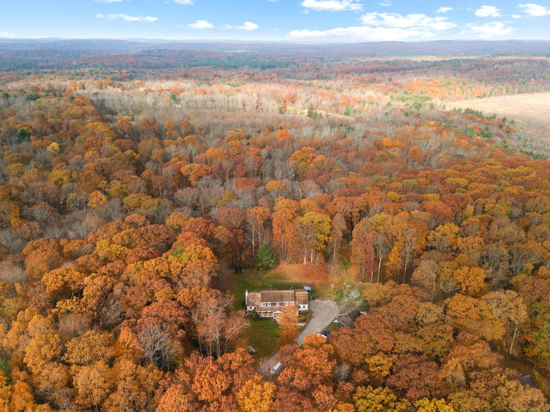 This beautiful sprawling custom colonial is set on 9 acres of land at the end of a winding long driveway and surrounded by open area.