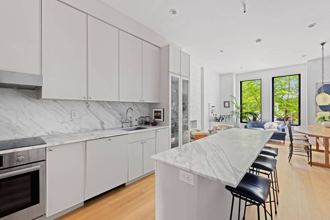 Nestled on a quiet, L shaped tree lined enclave in the heart of Clinton Hill, this interior designer's duplex condo is a rare marriage of historic character and bespoke modern ...