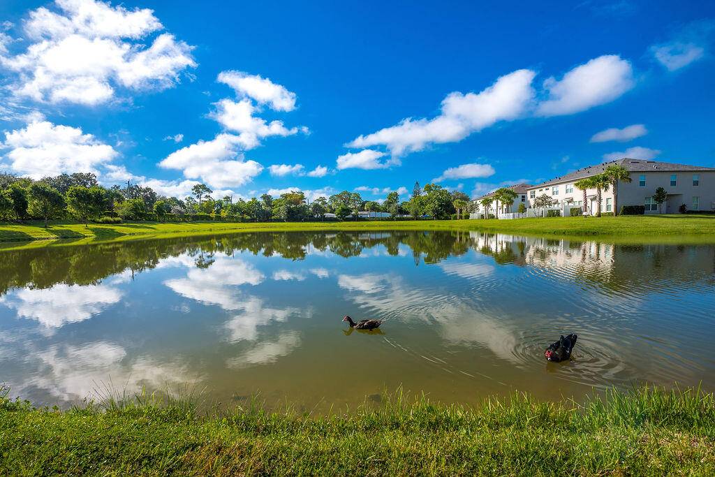 Bright, modern waterfront townhome built in 2023 with impact resistant windows, high ceilings and clean contemporary finishes.