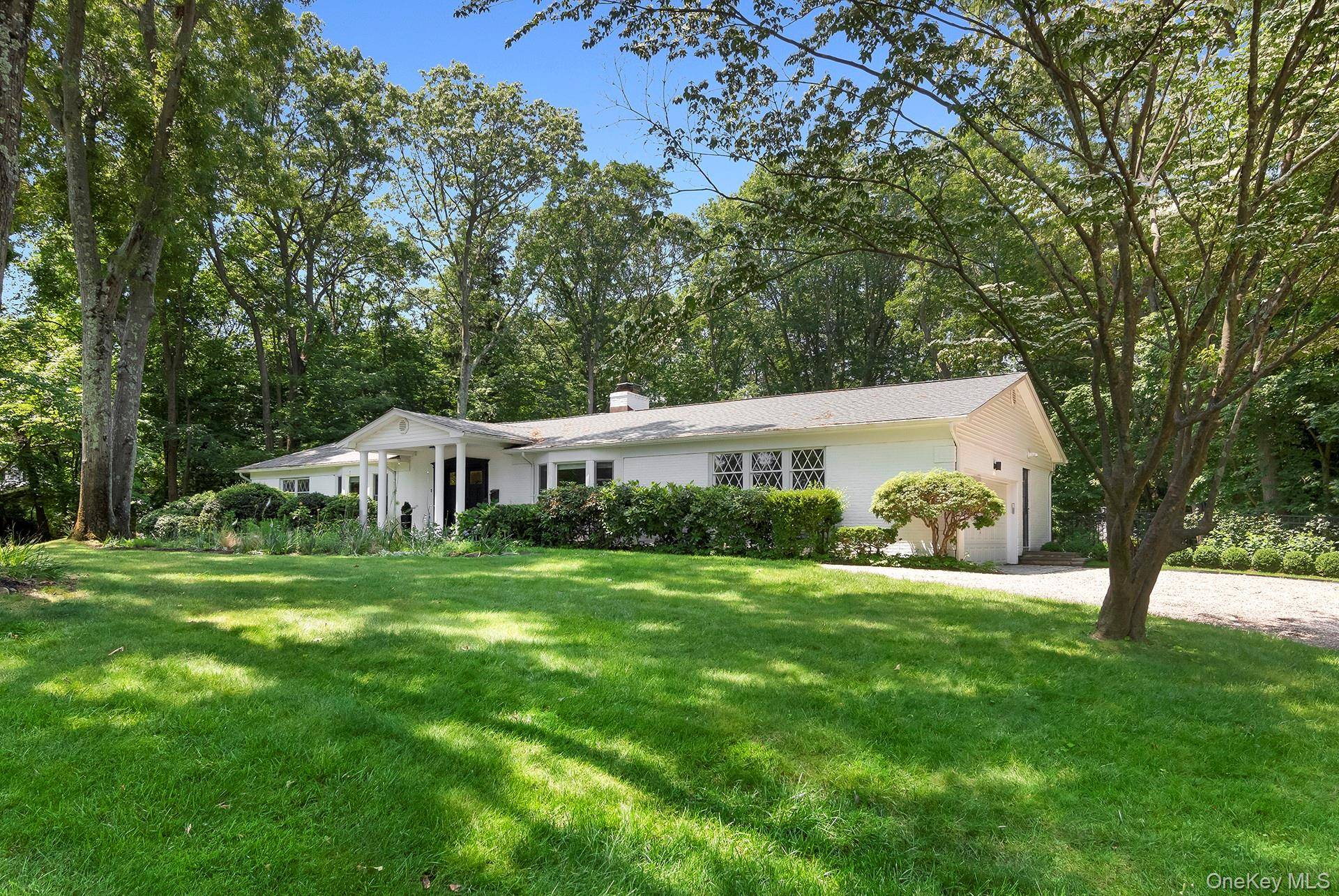 Lovingly Restored Mint Condition Modern 1964 Ranch in Belle Terre with a new pool and gorgeous landscaped grounds with weather smart irrigation.