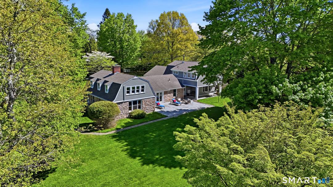 Tucked behind mature trees and framed by classic stone walls, this remarkable Stonington property feels more like a private country estate than a traditional residence.