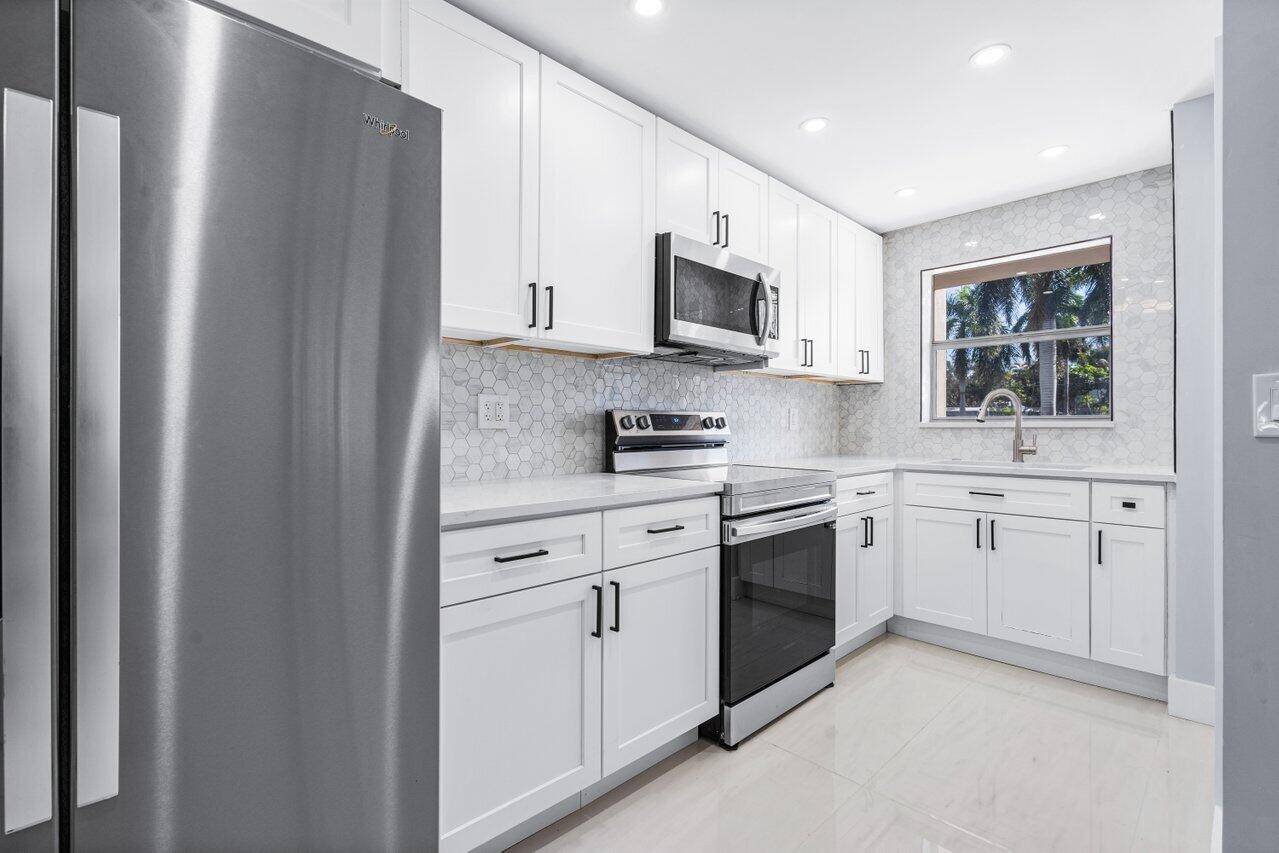 Exceptional completely renovated modern ground floor unit with 2 bedrooms, 2 full baths and never lived in and features screened in patio.