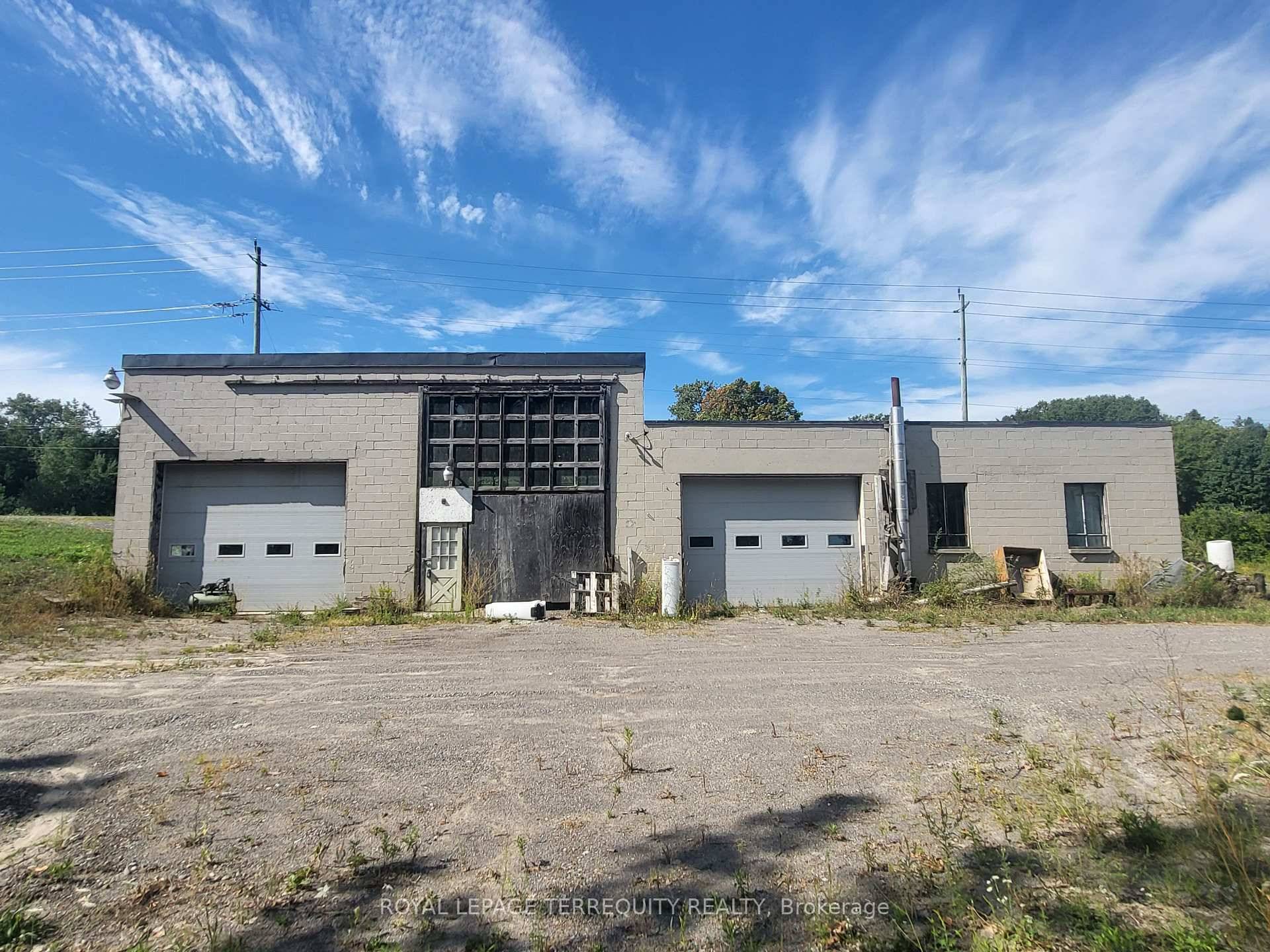 Rural mixed use property developed industrial building, storage outbuilding and small detached bungalow.