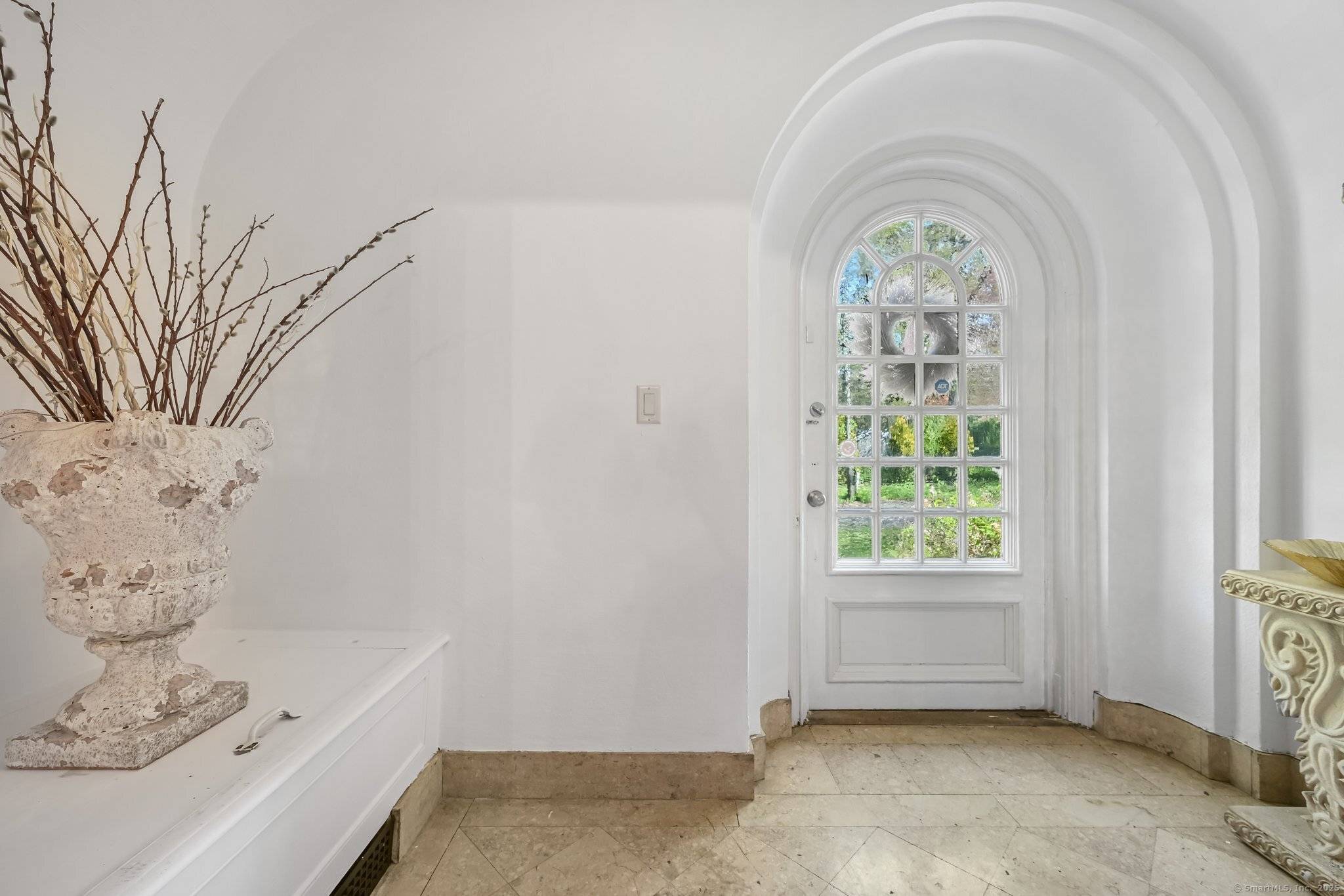 Nestled in New Haven's prestigious East Rock Prospect Hill neighborhood, this stunning 8, 430 sq ft Tudor mansion blends historic charm with modern luxury.