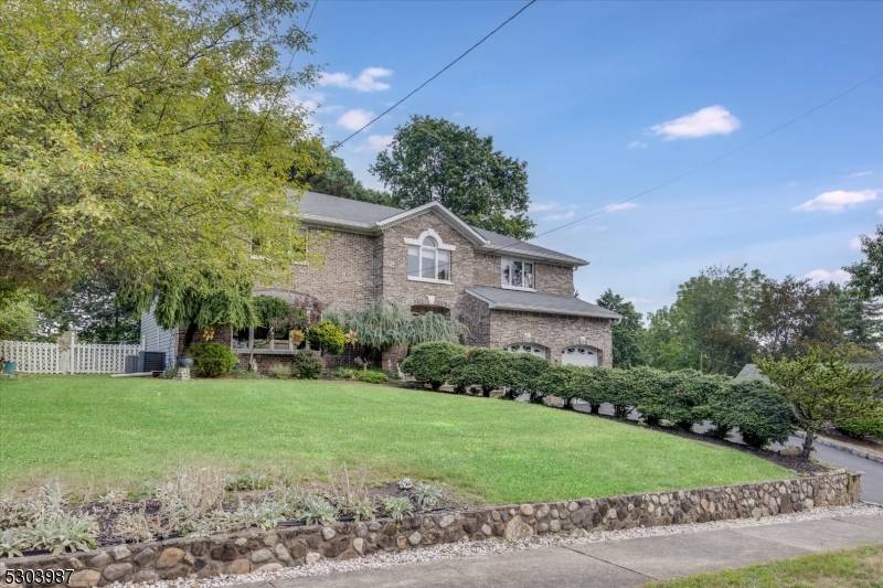 Charming Center Hall Brick Front Colonial on an oversized lot.