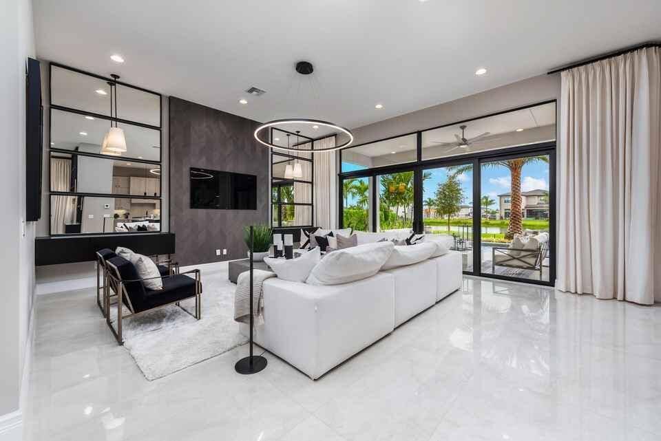 A stunning modern 4 bedroom loft media room 5 bathroom home featuring an open concept great room with a spacious kitchen and family dining area.