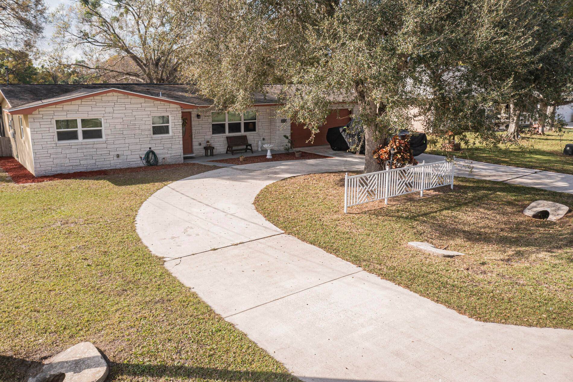 NEW ROOF COMING SOON ! Nestled under the mature Oaks this LAKEFRONT home is screaming pick me.
