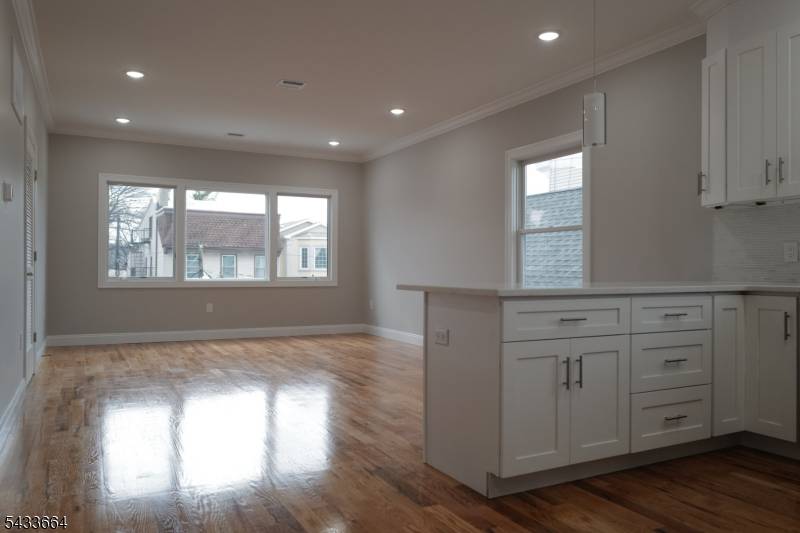 Beautiful newly constructed luxury two family residence featuring a modern open concept design, highlighted by a striking black brick exterior and sleek contemporary fa ade panels, ideally located in the ...