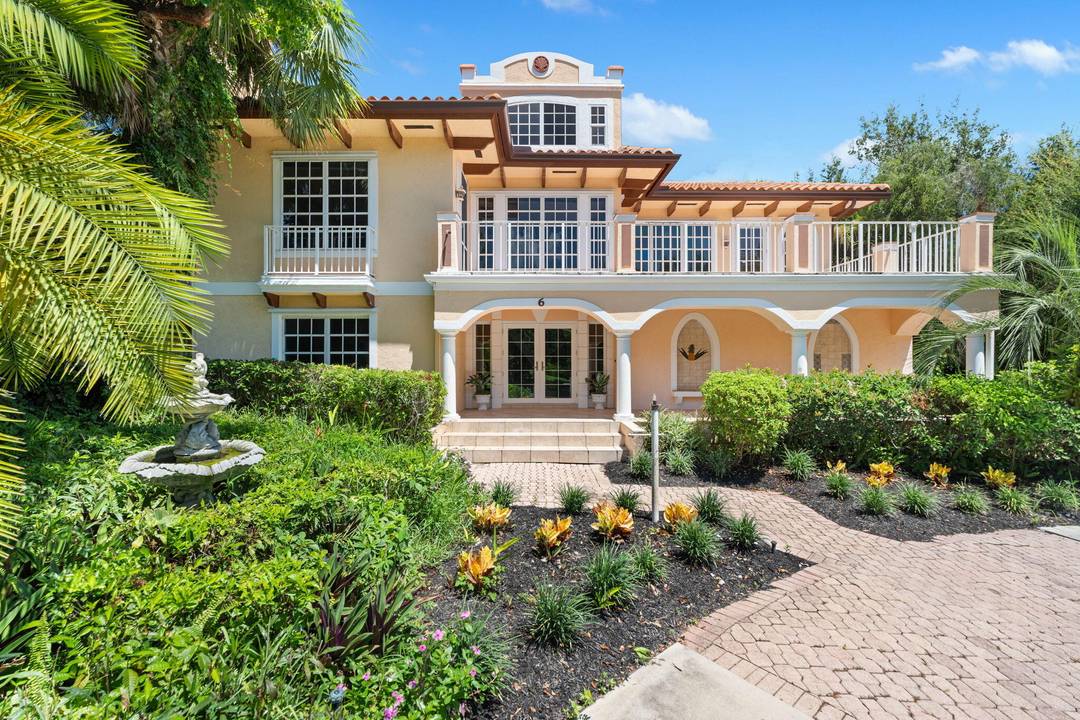 Perched at the top of Castle Hill in prestigious Sewall's Point, this custom Mediterranean style home is loaded with potential and curb appeal.