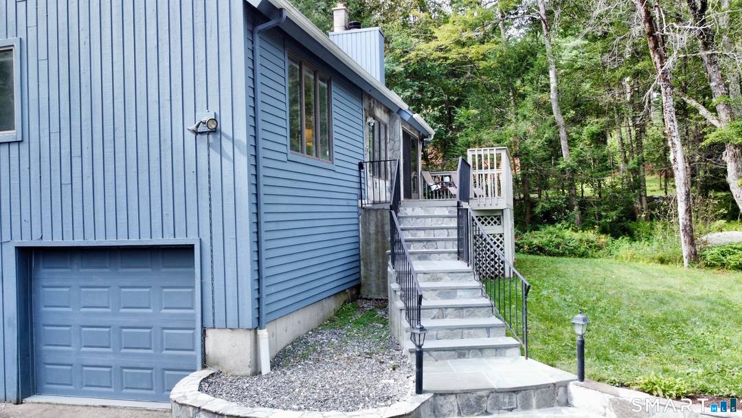 Set on a desirable second tier lot within the Woodridge Lake community, this four bedroom, two and a half bath residence offers peaceful lake views and a private wooded backdrop.