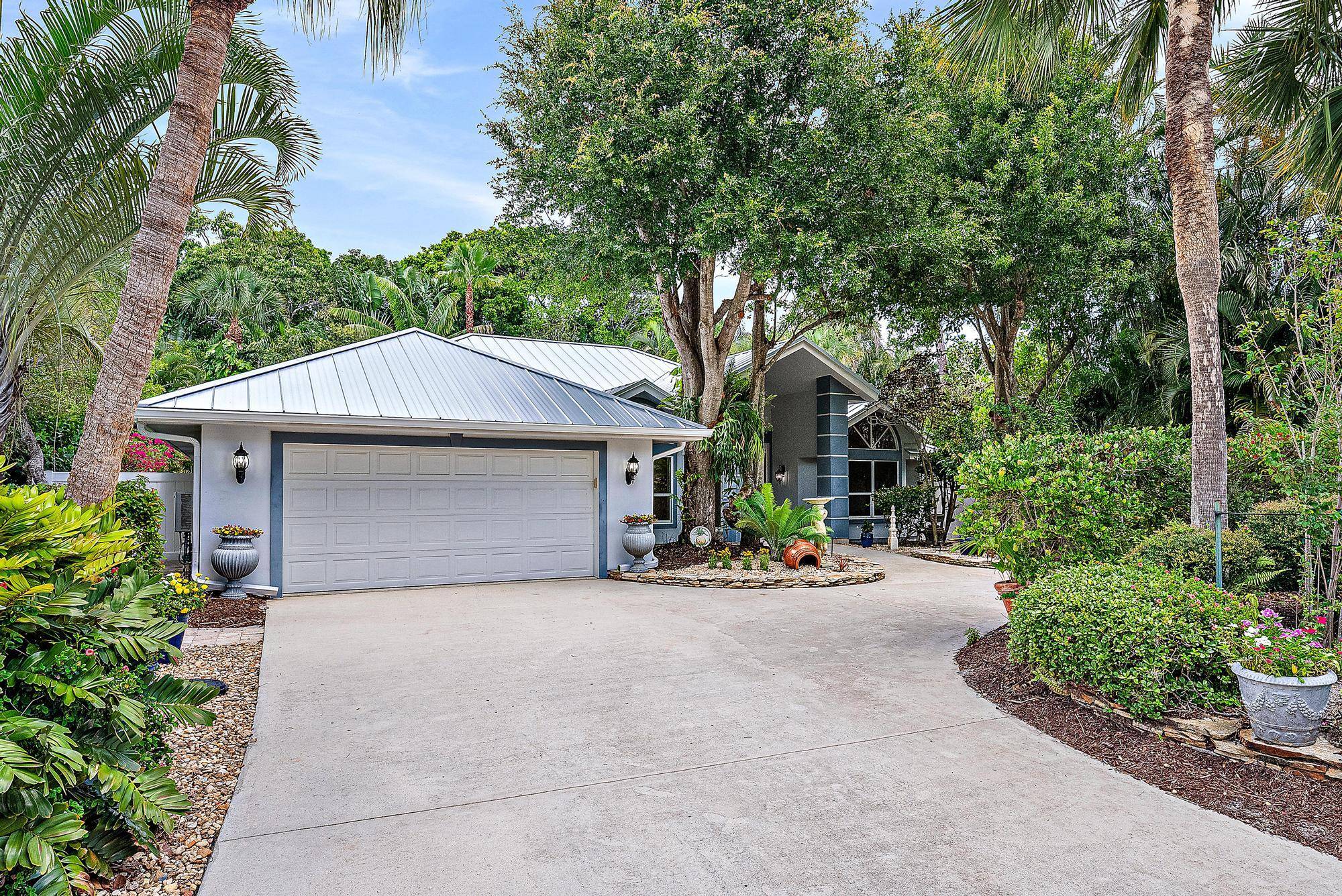 Set behind the gates of the exclusive Mystic Cove waterfront community, this architecturally striking home sits on an oversized, lushly landscaped lot.