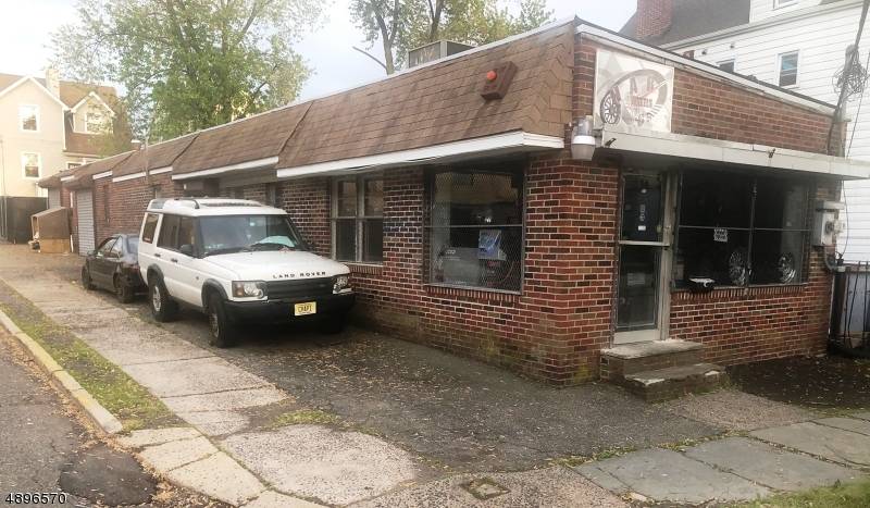 A warehouse Or Retail Storage Mixed Use one story building with two garage overhead doors.