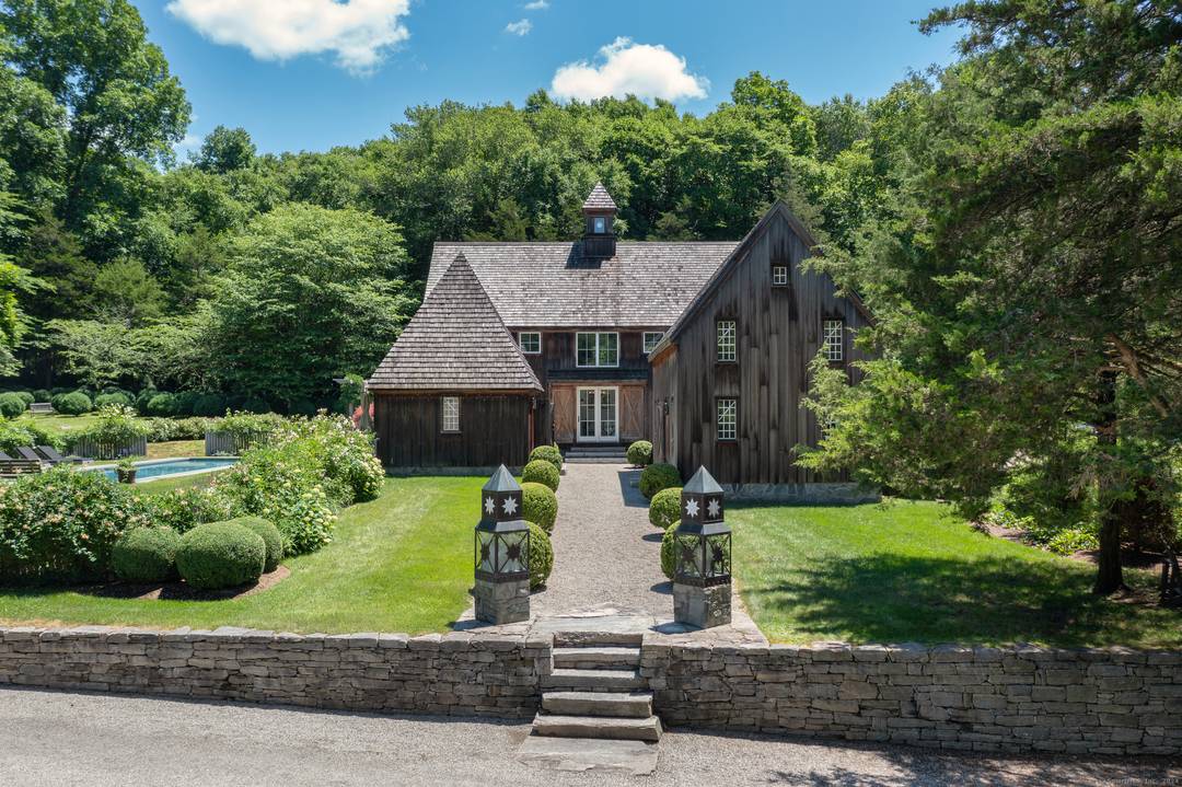 Located in the picturesque countryside of Lyme, this antique Sturbridge Village compound is a unique property consisting of three separate parcels that combine to create a stunning estate.