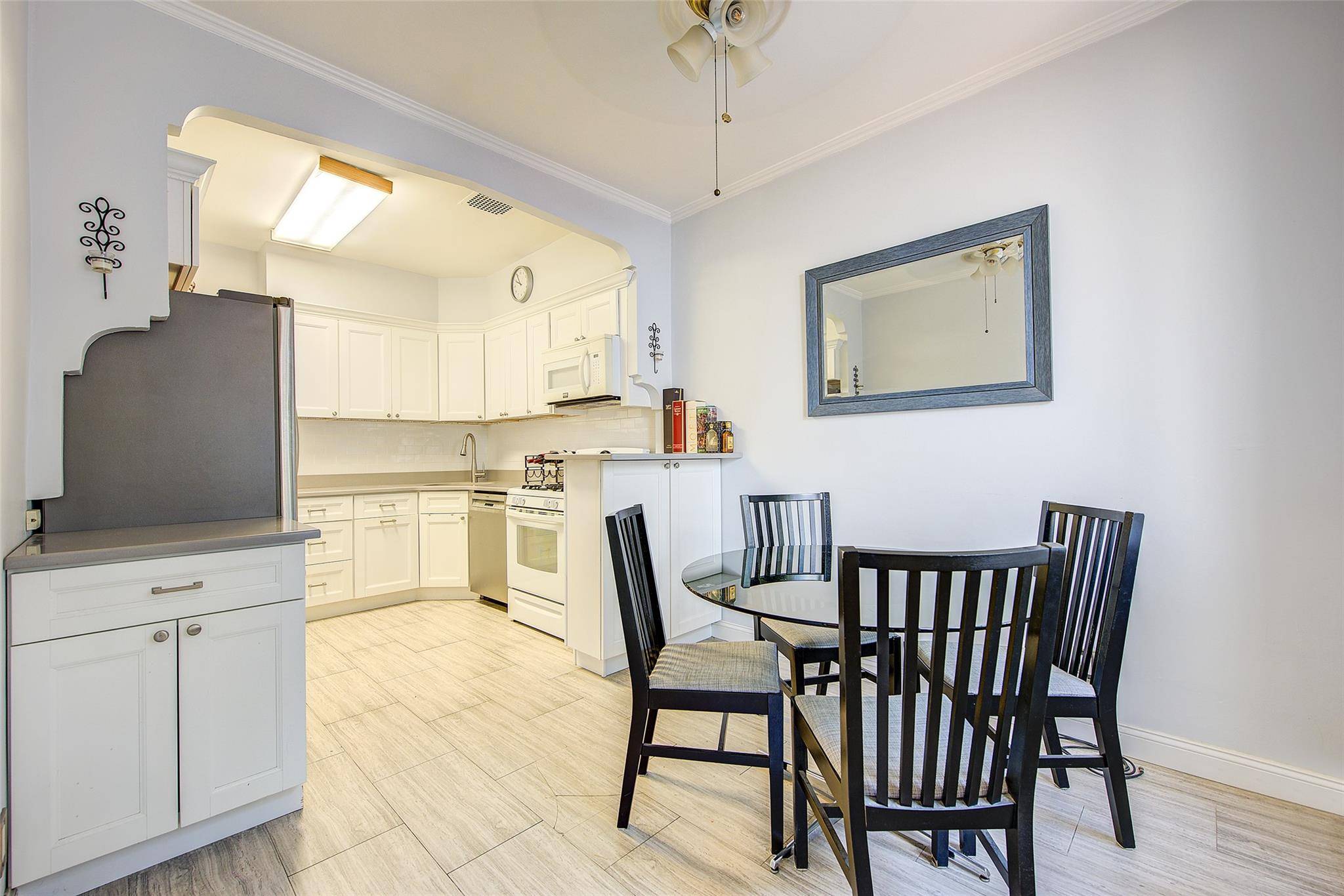 Charming single family attached home on a beautiful rowhouse block in Middle Village North.
