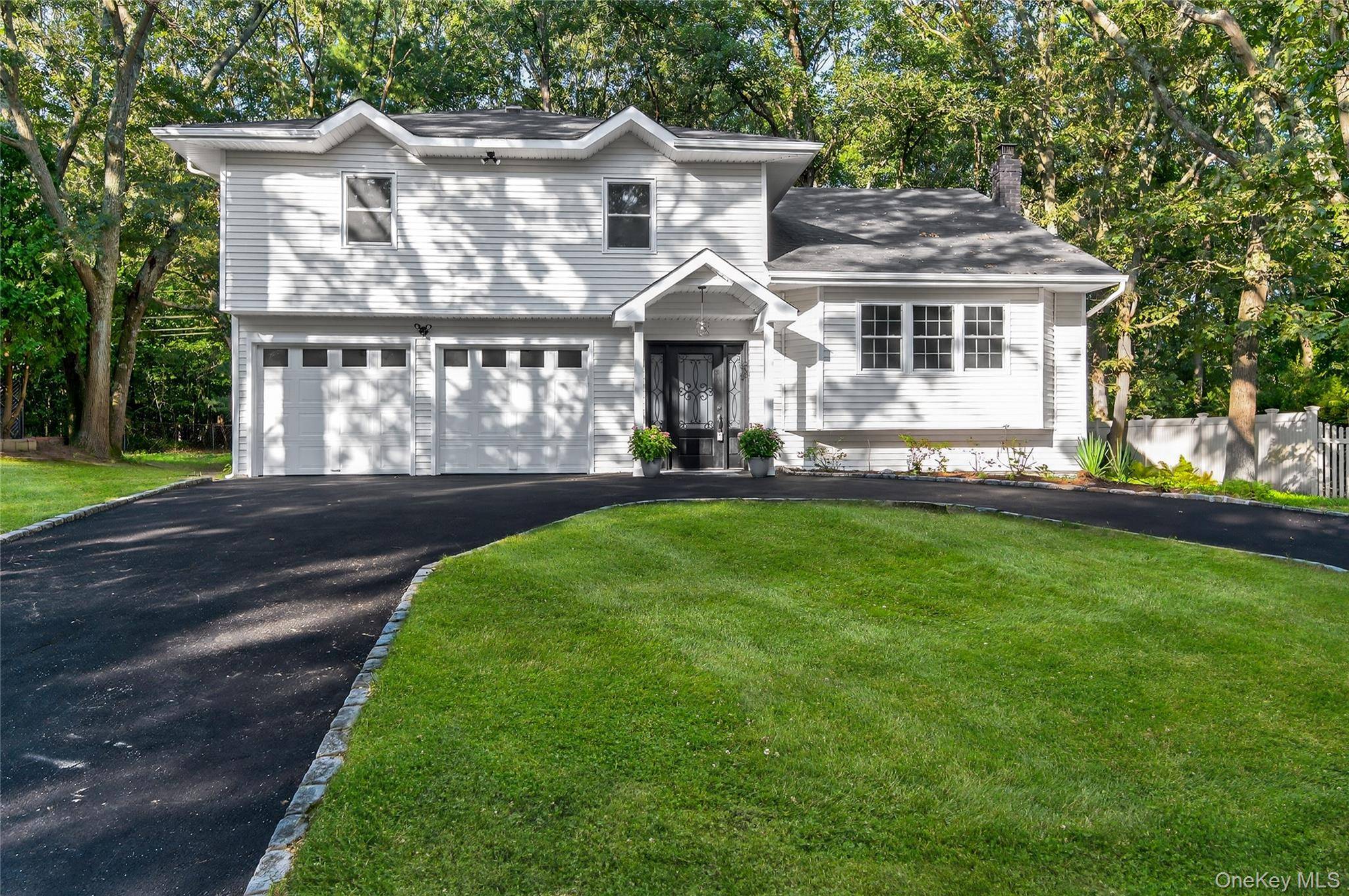 Discover this exceptional property in Smithtown Pines spanning over 3 4 acre on a rare half block lot directly across from a tranquil nature preserve.