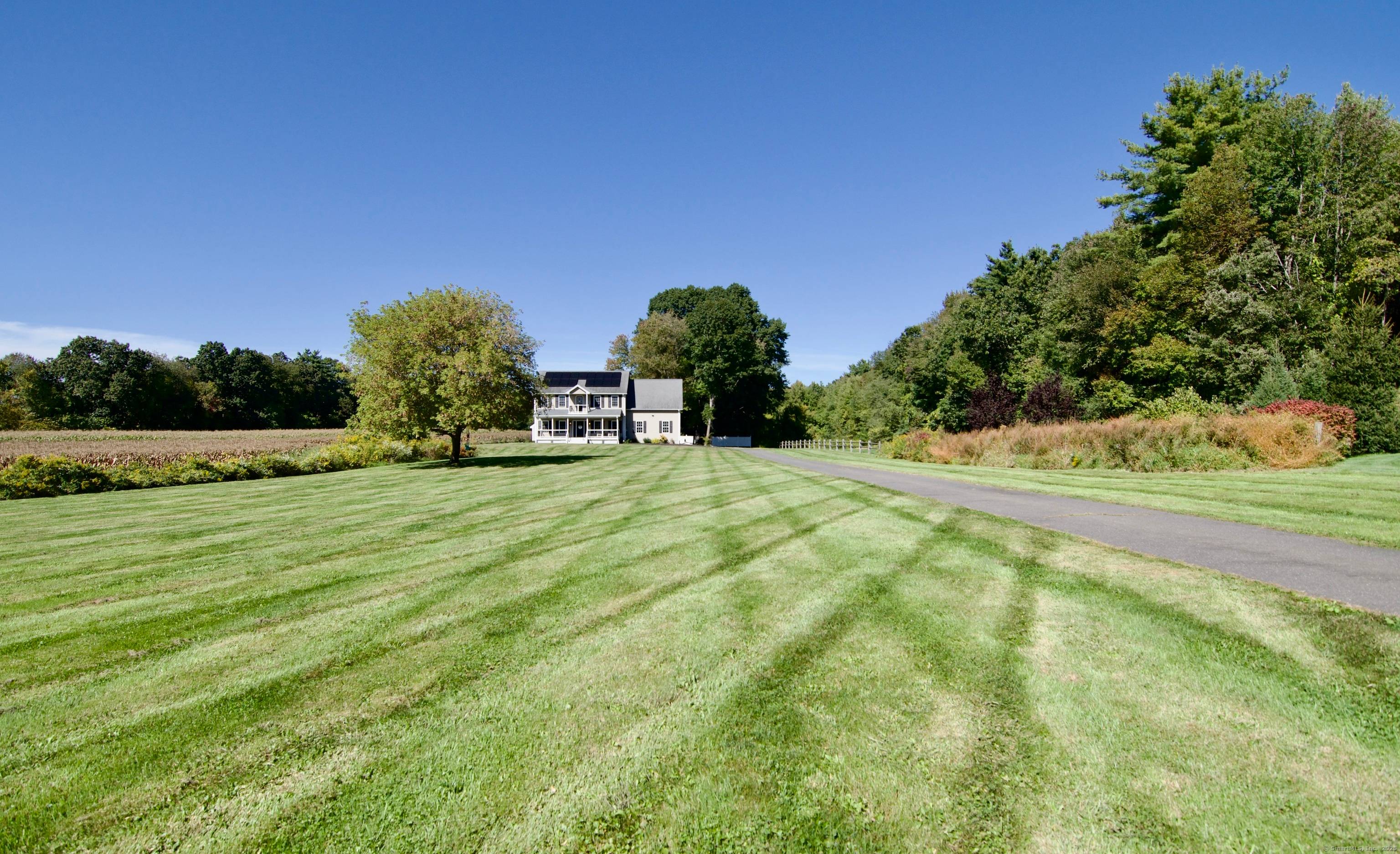 a beautifully maintained Colonial set on nearly 2 private acres in a desirable North Somers location.
