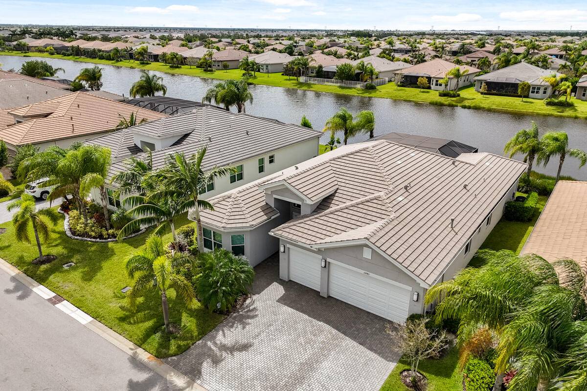 Welcome to this highly upgraded Julia model offering luxurious living on a premium waterfront lot with a widened paver driveway and walkway.