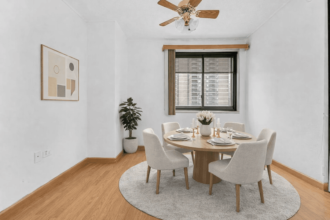 Large alcove studio with a southeast exposure, private balcony, and open city views extending toward the East River.