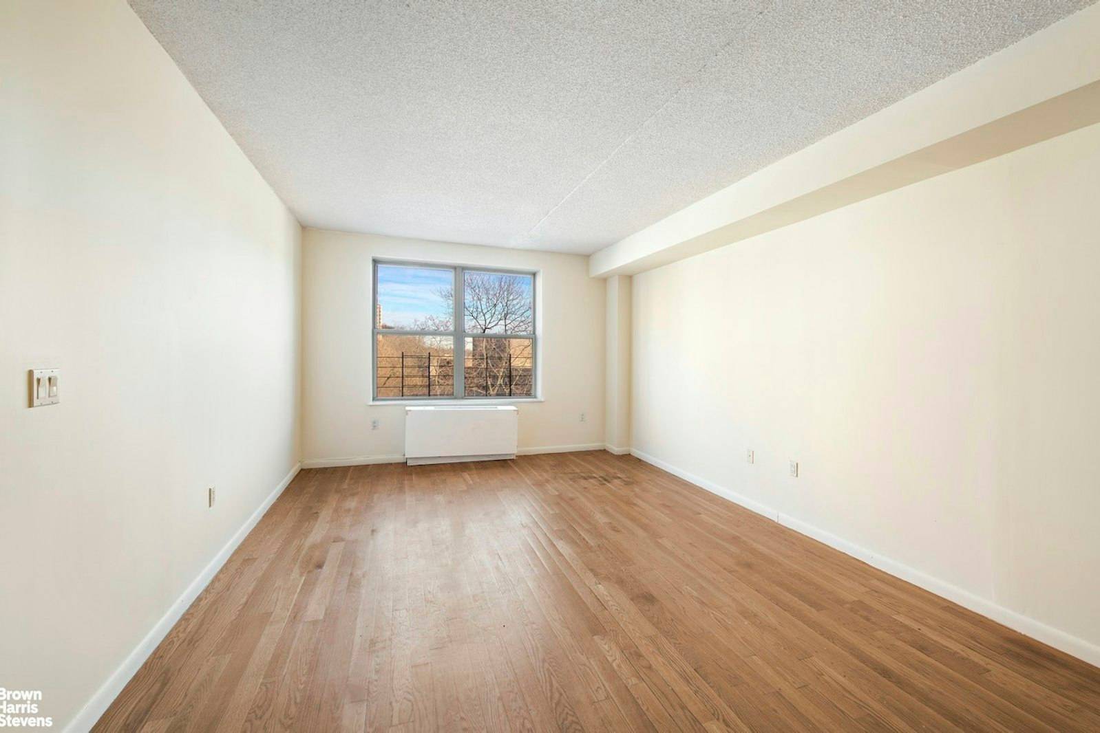 Bright and spacious 2 bedroom, 2 bath condo with an open kitchen featuring stainless steel appliances, including a dishwasher, granite countertops, and a breakfast island.