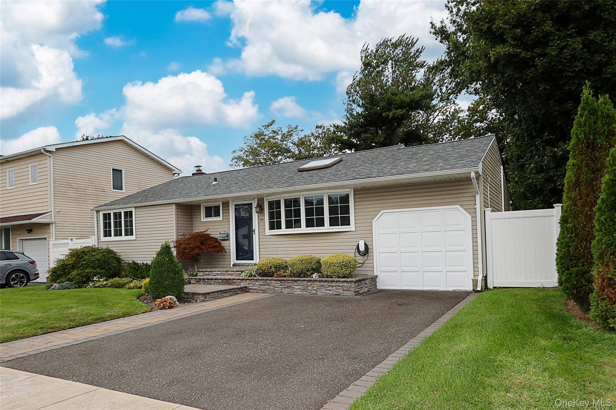 Welcome to this spacious and updated 3 bedroom, 3 bathroom home located mid block in Old Bethpage.