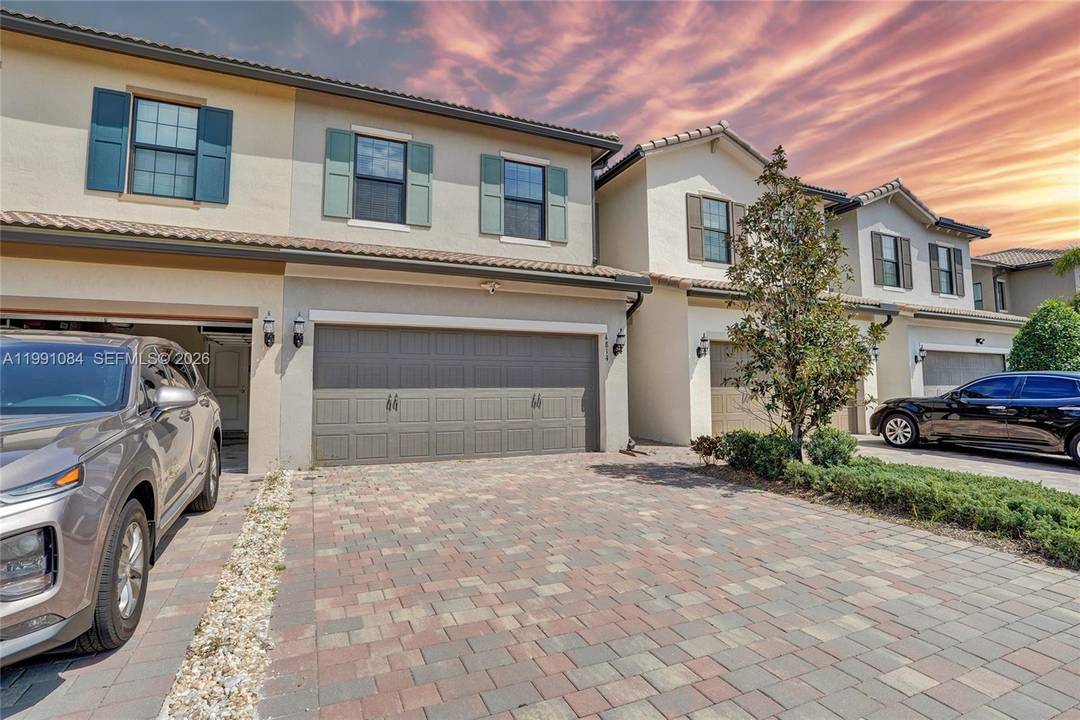A like new townhome with beautiful lake views in the highly desirable gated community of The Fields at Lake Worth by DiVosta Homes.