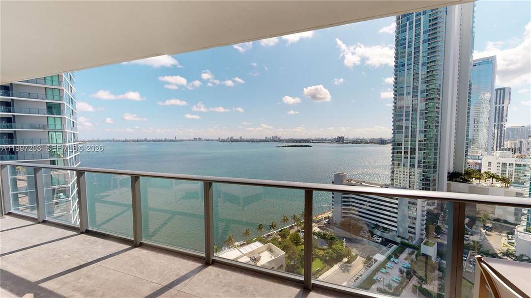 Sophisticated Furnished waterfront residence at Paraiso Bay featuring a private elevator entry that opens directly into a refined foyer, leading into a spacious open layout with unobstructed views of Biscayne ...