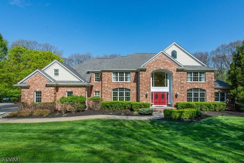 Tucked away at the end of a private cul de sac, surrounded by lush, wooded privacy, this exceptional 6 bedroom, 5.