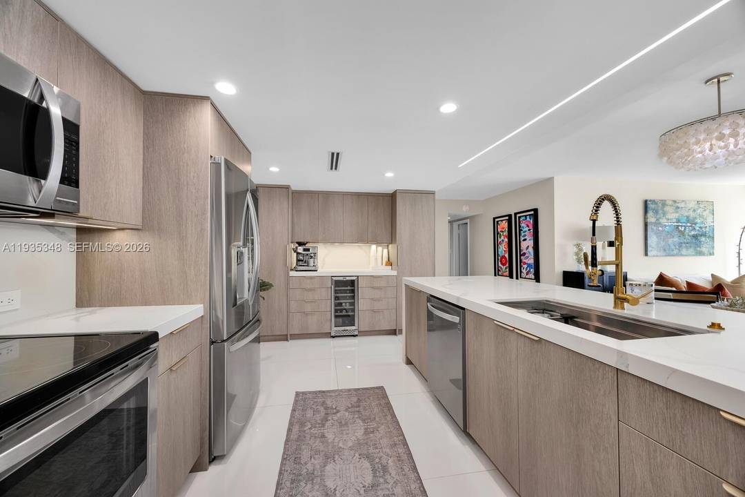 Beautifully remodeled 2 bedroom, 2 bath residence featuring a desirable open concept kitchen with sleek quartz countertops, an oversized peninsula with dramatic waterfall edge, stainless steel appliances, and elegant porcelain ...