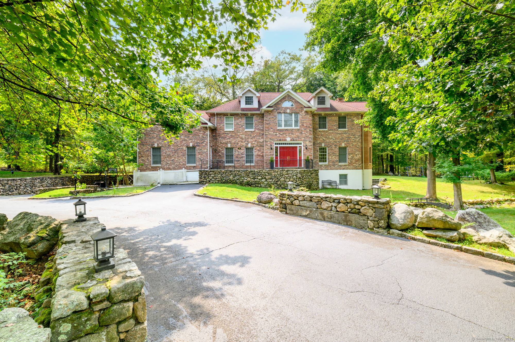 Set back from the road and set on two level acres, this stately all brick colonial feels private yet perfectly connected to everyday conveniences.